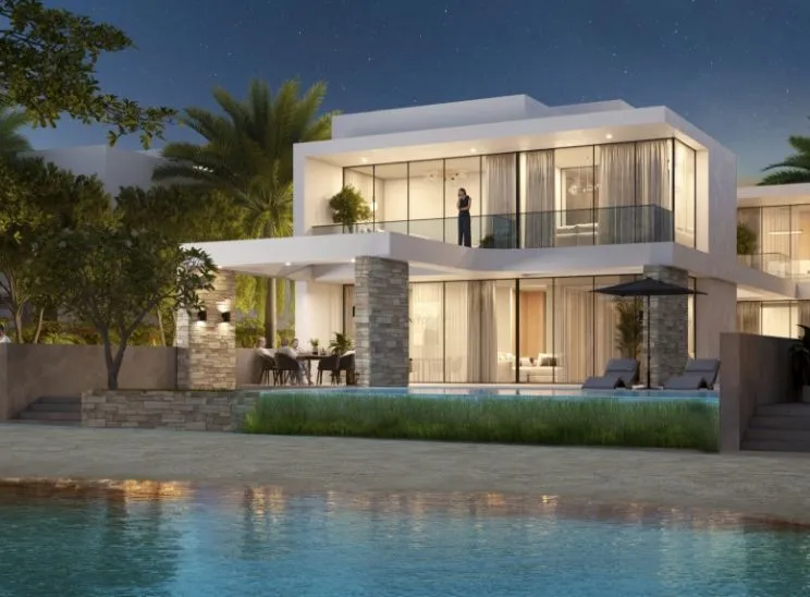 Render of a lit two-storey waterfront villa at Sobha Siniya Island at night